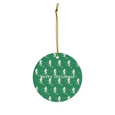 a green christmas ornament with a skier pattern and merry christmas written on it