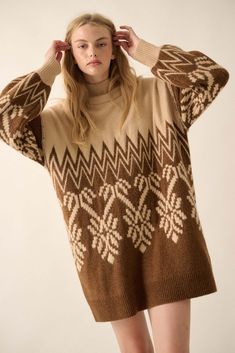 Alpine knit sweater. Geometric knit pattern with zigzag and snowflake designs. High mock neckline. Long bishop sleeves. Drop shoulder. Ribbed knit collar, cuffs, and hem. Thigh length. Oversized fit. 74% Acrylic, 22% Polyester, 4% Spandex. Imported. Designed in LA. Model wears size S. Beige Crew Neck Sweater Dress For Winter, Winter Sweater Dress With Ribbed Cuffs, Beige Turtleneck Sweater Dress For Winter, Brown Knitted Sweater Dress For Winter, Cozy High Neck Sweater Dress For Winter, Cozy Brown Winter Sweater Dress, Fall Jacquard Knit Long Sleeve Sweater Dress, Cozy Brown Sweater Dress For Winter, Long Sleeve Jacquard Knit Sweater Dress For Fall