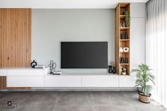 a living room with a large flat screen tv on the wall