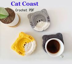 three crocheted animal coasters sitting next to a cup of coffee