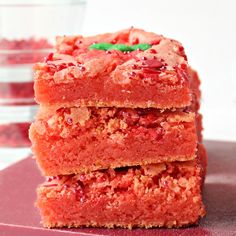 three pieces of cake sitting on top of a red plate