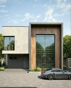 a car is parked in front of a modern house