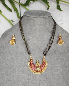 Length 18 inches Traditional forming Gold Plated Black bead Necklace , South Indian Traditional Festive Bridal Wear Jewellery for WomenFlaunt this temple jewelry with your ethnic wears/ saris. Needless to say the beads added elegantly all over the necklace makes them a show stopper. Festive Black Beaded Necklace For Celebration, Black Round Beads Necklace For Diwali, Temple Style Necklaces With Black Beads For Festivals, Black Beaded Necklace For Diwali, Black Beaded Necklaces For Diwali, Festive Temple Jewelry Necklace With Black Beads, Festival Temple Jewelry Necklace With Black Beads, Festive Black Necklaces For Celebration, Elegant Black Jewelry For Rituals