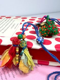 the book is decorated with beads and tassels