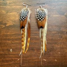 These earrings were crafted using a variety of rooster, pheasant, and guinea hen feathers. Approximately 6.5" in total length. Ear wires are nickel-free silver plated. Ready to ship. Brown Feather Dangle Earrings, Multicolor Feather Earrings Gift, Rooster Feathers, Western Boutique, Western Earrings, Blue Feather, Feather Jewelry, Pheasant, Feather Earrings