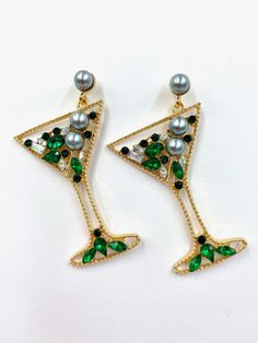 The Misty Martini Earrings are stunning statement earrings, sparkling from top to bottom; these earrings come in champagne gold, Green, and Multi-colour. These are the perfect party, festive, and girls' night out earring that is sure to have everyone asking you about them. Put a smile on your face with these showstoppers! Stud style closure You will receive a spare set of backs for every pair of earrings purchased MOST POPULAR IN STORE 6.2cm x 4.7cm weight 12 g (pair) Elegant Pearl Earrings With Sparkling Stones For Party, Gold Jewelry For Holiday Party, Holiday Party Gold Jewelry, Dangle Pearl Earrings For Party, Elegant Holiday Party Jewelry, Metal Crystal Earrings For Party, Party Earrings With Rhinestones, Metal Crystal Earrings For Pierced Ears For Party, Silver Crystal Bling Earrings For Party