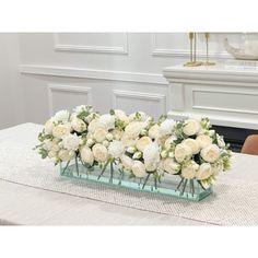 there is a vase with white flowers on the table