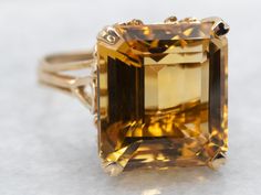 Transform your look with solitaire ring. The stunning emerald cut citrine stone set in yellow gold adds a touch of elegance and sophistication to any outfit. A perfect statement piece for any occasion. Metal: 14K Yellow Gold Gem: Citrine 9.11 Carats Gem Measurements: 11.8 x 13.1 mm, Emerald Cut Ring Size: 6.25 Marks: "14K" Stamped on the inside band SKU #: A40402 Each piece has been identified and graded by a Graduate Gemologist who has been certified by the Gemological Institute of America (GIA Formal Emerald-cut Solitaire Topaz Ring, Formal Emerald Cut Solitaire Topaz Ring, Fine Jewelry Yellow Gold Octagon Topaz Ring, Yellow Gold Octagon Topaz Ring Fine Jewelry, Yellow Gold Octagon Topaz Ring, Yellow Gold Octagon Topaz Ring In Fine Jewelry Style, Yellow Emerald-cut Topaz Ring, Formal Yellow Gold Topaz Ring With Rectangular Stone, Classic Gold Topaz Ring With Baguette Cut