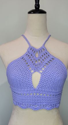 a mannequin wearing a purple crochet halter top with cut outs