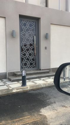 a black door is on the side of a building