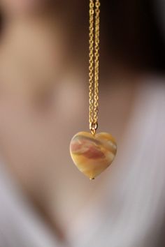 This delicate unique necklace was made of natural mother of pearl beige heart pendnat and high quality gold tone stainless steel chain with gold tone lobster claw. The chain is from lead & nickel free metal. Perfect jewelry for everyday wear and a great gift for someone special! The length of necklace is 45 cm or 17.7 inches. Other necklaces of my shop you can see here: https://www.etsy.com/shop/NaTavelli?section_id=14843046&ref=shopsection_leftnav_5 Thanks for a visit. Gold Chalcedony Jewelry As A Gift, Jade Pendant Necklaces For Crafting, Agate Necklaces With Natural Stones, Elegant Heart-shaped Gemstone Bead Jewelry, Minimalist Handmade Heart Pendant Necklace, Adjustable Round Necklace With Heart Beads, Jade Necklaces With Round Beads For Gifts, Heart Bead Pendant Necklace As Gift For Her, Handmade Mother Of Pearl Round Pendant Necklace