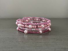 Memory wire wrap bracelet in pink glass beads is just what you've been waiting for! Strung on memory wire, this gives the appearance of four bracelets stacked, however it is one piece. Bracelet measures 7 inches around, but will expand due to the flexibility of memory wire.  This is a must have to add to your jewelry collection! Wear daily or with your favorite pink outfits! Handmade Pink Wrap Bracelet With Round Beads, Adjustable Pink Beaded Wrap Bracelet, Pink Wrap Bracelet With Round Beads For Gifts, Beaded Pink Wrap Bracelet Gift, Stackable Pink Beaded Bracelets With Round Beads, Pink Hand-strung Bangle Stretch Bracelet, Pink Stackable Beaded Bracelets With Round Beads, Adjustable Pink Multi-strand Beaded Bracelets, Pink Beaded Wrap Bracelet As Gift