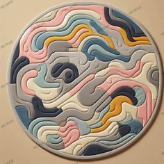 a round rug with an abstract design on the inside of it, in pastel colors