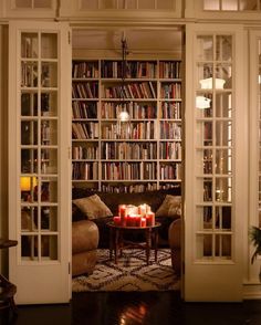 a living room filled with furniture and lots of books