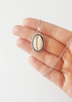 "A Sterling silver Cowrie Pendant - The prefect necklace for your bohemian looks ! *It has been made from scratch by me using sterling silver sheet and wire. *Finished with a black patina and brought to a shine. * 18\" Long -Hanging from a sterling silver chain . *You can find the matching ring here: https://www.etsy.com/listing/676737408/sterling-silver-cowrie-shell-ring-sea?ref=shop_home_active_2&frs=1 *This necklace is made to order.Please up to 1 week to have it ready for you.It will com Boho Looks, Cowrie Shell Necklace, Shell Ring, Matching Ring, Bohemian Beach, Rose Quartz Ring, Boho Pendant, Bohemian Rings, Summer Necklace