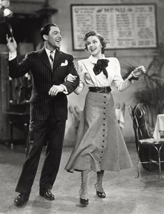 an old black and white photo of two people dancing