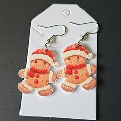 Christmas Dangle Earrings, Gingerbread Wearing Santa Hat. Plastic And Base Metal Fish Hook Backing. New Metal Fish, Jewelry Christmas, Santa Hat, Fish Hook, Base Metal, Gingerbread, Dangle Earrings, Jewelry Earrings, Women Jewelry