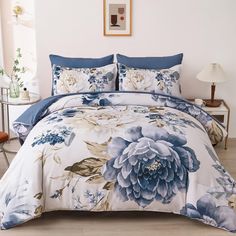 a bed with blue and white flowers on it