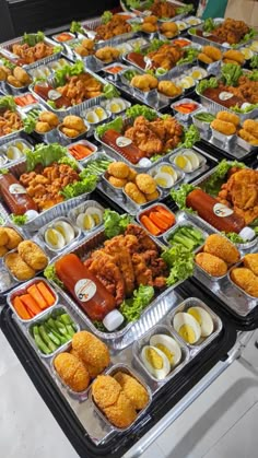 many trays filled with different types of food