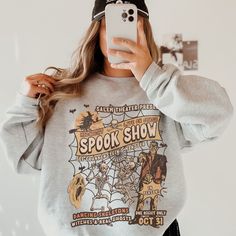 This Halloween Shirt has a retro vibe with a fun Monster Mash themed graphic. Celebrate Spooky Season with a cute Fall shirt that you will want to wear on repeat.  This is a relaxed fit unisex sweatshirt, but true to size. We recommend sizing up if you want a trendy oversized look. - M A T E R I A L S - Gildan® Sweatshirt 8 oz./yd² (US) 50/50 cotton/polyester Heather Sport colors: 60/40 polyester/cotton Loose Fit Ribbed Knit Collar to retain shape - C A R E  I N S T R U C T I O N S - Inside out, Vintage Halloween Sweatshirt For Streetwear, Retro Fan Merchandise Tops For Fall, Retro Fall Tops For Fan Merchandise, Halloween Fan Merchandise Sweatshirt With Graphic Print, Vintage Crew Neck Halloween Tops, Vintage Crew Neck Tops For Halloween, Pop Culture Graphic Print Sweatshirt For Fall, Vintage Relaxed Fit Top For Halloween, Pop Culture Graphic Print Tops For Fall