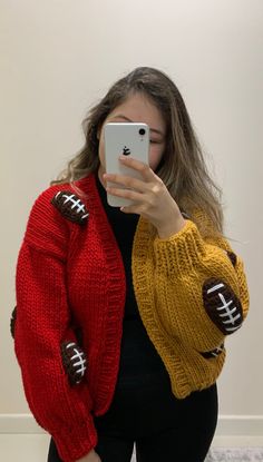 a woman is taking a selfie with her cell phone while wearing a football sweater and leggings