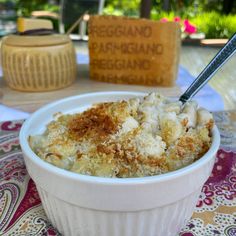 a white bowl filled with food on top of a table