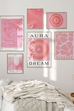 a bedroom with pink and white art on the wall