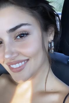 a woman sitting in the back seat of a car