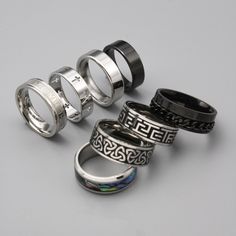 Choose from 8 of our high-quality stainless steel silver men's rings. Including: 1. Saint Cross ring 2. Celtic Knot Ring 3. Aztec Numeral Ring 4. Roman Band Ring  5. Black Classic Band Ring 6. Classic Band Ring 7.Abalone Shell Ring  8. Black Chain Ring ➤Weighty and Durable Stainless Steel ➤The perfect, versatile ring for daily wear ➤Multiple Sizes available ➤Made with High-Quality 316L Stainless Steel for a premium finish Please Note: This includes 1 ring not a full set of 8. Please pick the style that you would like from the photos. Please check our size chart in the last image before ordering. Shipping: We aim to ship your order out as soon as possible and offer Free First Class Delivery to the UK. We also offer worldwide shipping which we send with international standard delivery. Any q Black Stainless Steel Couple Rings For Promise, Adjustable Silver Titanium Rings, Modern Silver Stainless Steel Couple Rings, Durable Silver Promise Ring, Durable Silver Metal Ring, Silver Titanium Promise Ring, Unisex Rings, Set Of Rings, Streetwear Jewelry