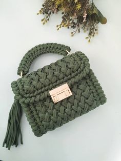 a green purse sitting on top of a white table