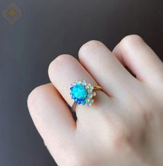 "Natural multi gemstone opal ring, oval shape natural Australian center opal stone surrounded by color shifting round crystal opals. Let your eyes get lost staring into the deep blue beauty of this ring, truly stunning and unique piece. In our original design, the ring band is in two colors which stands for ice and fire. But you will have the option to decide if you would like to have only one color for the band. 💎 Metal: 14k gold/14k white gold/14k rose gold, 18k gold/18k white gold/18k rose g Ethiopian Opal Oval Ring For Wedding, Exquisite Multi-stone Oval Opal Ring, Exquisite Oval Multi-stone Opal Ring, Unique Multi-stone Oval Opal Ring, Unique Oval Opal Ring For Anniversary, Exquisite Oval Opal Ring, Anniversary Multi-stone Opal Ring, Ethiopian Opal Multi-stone Ring, Opal Ring With Halo Design As A Gift