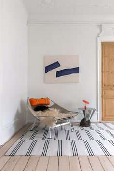 a living room with white walls and wooden floors