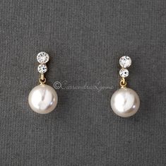 A larger pearl drop earring set of light ivory pearls that hang from two small round crystals. A classic looking wedding day earring style! They are silver or gold plated, titanium posts, 12mm synthetic pearls and 1 inch long. Hanging Pearl Earrings, Pearl Hanging Earrings Gold, Classic Pearl Drop Earrings For Wedding, Classic White Pearl Bridal Earrings, Classic Pearl Earrings For Wedding, Classic Round Pearl Drop Bridal Earrings, Classic Pearl Chain Bridal Earrings For Anniversary, Classic Bridal Earrings With Pearl Chain For Anniversary, Classic Pearl Embellished Drop Earrings