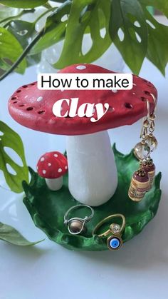 a small red mushroom sitting on top of a green leafy plant with the words how to make clay