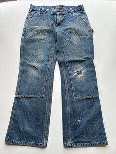 Mens Carhartt Double Knee Trouser Heavy duty material 1990s vintage  Regular Fit  Zip Fly  Blue Waist 35 inch Leg Length 29.5 inch **Sizes are exact measurement of the jean and may differ from the tag size** Please note due to the nature of these being workwear jeans there will be cool signs of fraying / paint and fading marks. All adding to the character of the piece** Item in great workwear condition overall Vintage Straight Leg Cargo Jeans For Streetwear, Vintage Straight Leg Cargo Pants For Streetwear, Vintage Full-length Cargo Jeans For Streetwear, Vintage Full Length Cargo Jeans For Streetwear, Vintage Distressed Cargo Jeans For Streetwear, Vintage Five Pockets Pants For Streetwear, Vintage Straight Leg Cargo Pants With Five Pockets, Vintage Full-length Cargo Jeans, Vintage Cargo Pants For Streetwear