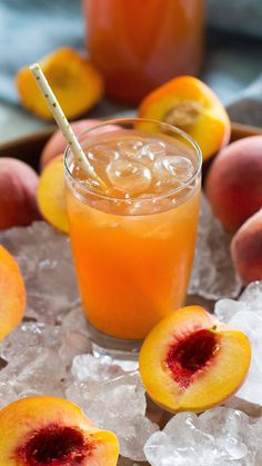 two peaches and some ice on a tray with fruit in the backgroud