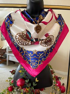 a pink and blue scarf on top of a mannequin's head in front of a mirror