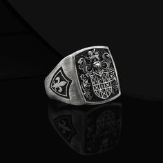 Custom Crest Signet Ring Coat Of Arms Ring Custom Rings For Men Silver Crest Signet Coat Of Arms Ring Men Unique Heraldic Family Crest Ring Made to Order Designs Details Metal: 925k Sterling Silver Weight:18-20 gram Color: Oxidized Silver Color ( color customizable ) Style: Family Crest / Coat Of Arms Dimensions : 0.7 x 0.7 inch Can be personalized  3D Style Handmade Design Contact us at this link freyjewelrydesign.etsy.com Personalized Engrave Service ● Design Silver Rings ● Custom Personalized Gift ● 925k Sterling Silver Material  ● Personalized Heraldic Ring ● Personalized Jewelry  ● Custom Engrave Ring ● Custom Engrave Ring ● Custom Family Crest Ring  ● Coat Of Arms Silver Ring  ● Signet Ring Man  ● Personalized Heraldic Ring  ● Unique Silver Rings For Man Custom Design Gift ● This Han Classic Formal Rings With Coat Of Arms, Classic Coat Of Arms Collectible Rings, Classic Coat Of Arms Ring, Classic Coat Of Arms Jewelry For Collectors, Classic Coat Of Arms Collectible Jewelry, Vintage Silver Jewelry With Coat Of Arms, Silver Heirloom Signet Ring Tarnish Resistant, Heirloom Silver Tarnish-resistant Signet Ring, Classic Sterling Silver Jewelry With Coat Of Arms