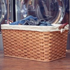 a laundry basket sitting in front of a washing machine