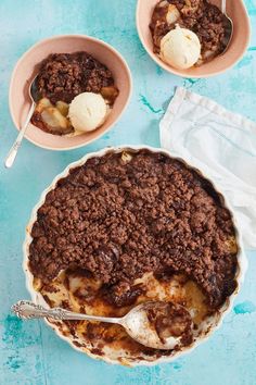 two bowls filled with dessert on top of a blue table