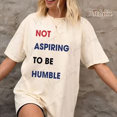 Make a powerful statement with our Not Aspiring To Be Humble Shirt, designed for proud Feminists! This bold Feminist Girl Power T-shirt is perfect for Democrats and advocates of Women Empowerment. Whether you're wearing it to show off your values or gifting it to a fellow feminist, this tee is a stylish way to champion equality and confidence. The perfect Feminist Gift for Her, it's a must-have for any woman who stands unapologetically strong, making her voice heard in the fight for progress and empowerment! 👌Super Soft & Comfortable: These short sleeve t-shirts are light, comfortable, and have the perfect amount of stretch, making them an ideal daily garment for both men and women. They won't shrink and may become even softer after washing. With your favorite printed image, this will qui Feminist Tee Shirts, Feminism Clothes, Girl Power T Shirt, Feminist Fashion, Feminist Tshirt, Feminist Tees, Merch Ideas, Be Humble, Her Voice