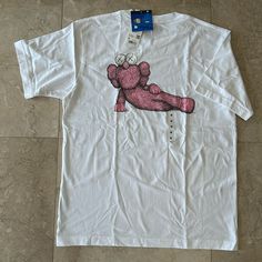 Uniqlo Kaws Unisex White And Pink Short Sleeve T-Shirt In Size M. Uniqlo And Kaws Have Done It Again And Collaborated To Create These Unique Limited Edition Design Tees. Material: 100% Cotton Measurement: Armpit To Armpit 21” Top To Bottom 27.5” White Short Sleeve Top With Front Print, White Relaxed Fit Top With Front Print, White Tops With Front Print And Relaxed Fit, White Top With Front Print And Relaxed Fit, White Top With Front Print In Relaxed Fit, White Printed Relaxed Fit Tops, White Cotton Top With Front Print, White Cotton Shirt With Front Print, Uniqlo Crew Neck Graphic Print Tops