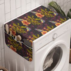 a white washer sitting next to a dryer on top of a tiled floor