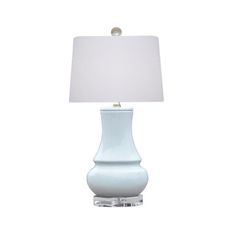 a white table lamp with a light blue shade on the base and a white square shaped lampshade