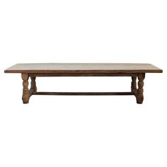 a wooden table sitting on top of a white wall