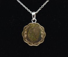 Vintage 10 senti brass coin from Tanzania, with a sterling silver bail, set on a sterling silver chain necklace. The coin features a profile depiction of the first president of Tanzania, Julius Nyerere is from 1984 and has a zebra on the back. Pendant - 1 3/8 x 1" - 5.6g - Marked - "925 JCM" Chain - 18 inches long - 3g - Marked - "925 JCM" Silver Coin-shaped Medallion Necklace In Brass, Classic Coin Jewelry For Commemoration, Classic Coin Pendant Necklace For Commemoration, Classic Coin Necklace With Polished Finish, Classic Coin Shaped Necklace With Polished Finish, Coin Necklace With Polished Finish For Anniversary, Formal Round Medallion Necklace With Coin Pendant, Coin Shaped Necklace With Polished Finish For Anniversary, Nickel-free Medallion Necklace For Commemoration