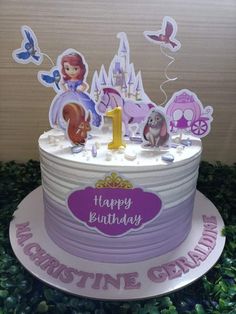 the birthday cake is decorated with princesses and other things to celebrate it's first birthday