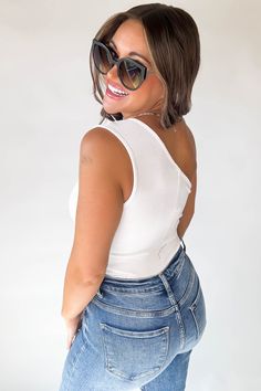 Get ready to show off your curves with our Mable White One Shoulder Ribbed Cut Out Detail Body Suit! This stretchy and stylish piece features playful cutouts that add a touch of sass to any outfit. Perfect for a fun night out or a trendy daytime look. Fit: She is wearing her true size medium. Fits true to size. If in between sizes, size down. Body Suit, Online Boutique, Latest Fashion, Night Out, Cut Out, One Shoulder, Product Launch, Size Medium, How To Wear