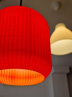 a red lamp hanging from the ceiling in a room