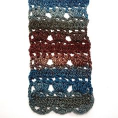 three crocheted pieces of yarn sitting on top of each other in different colors